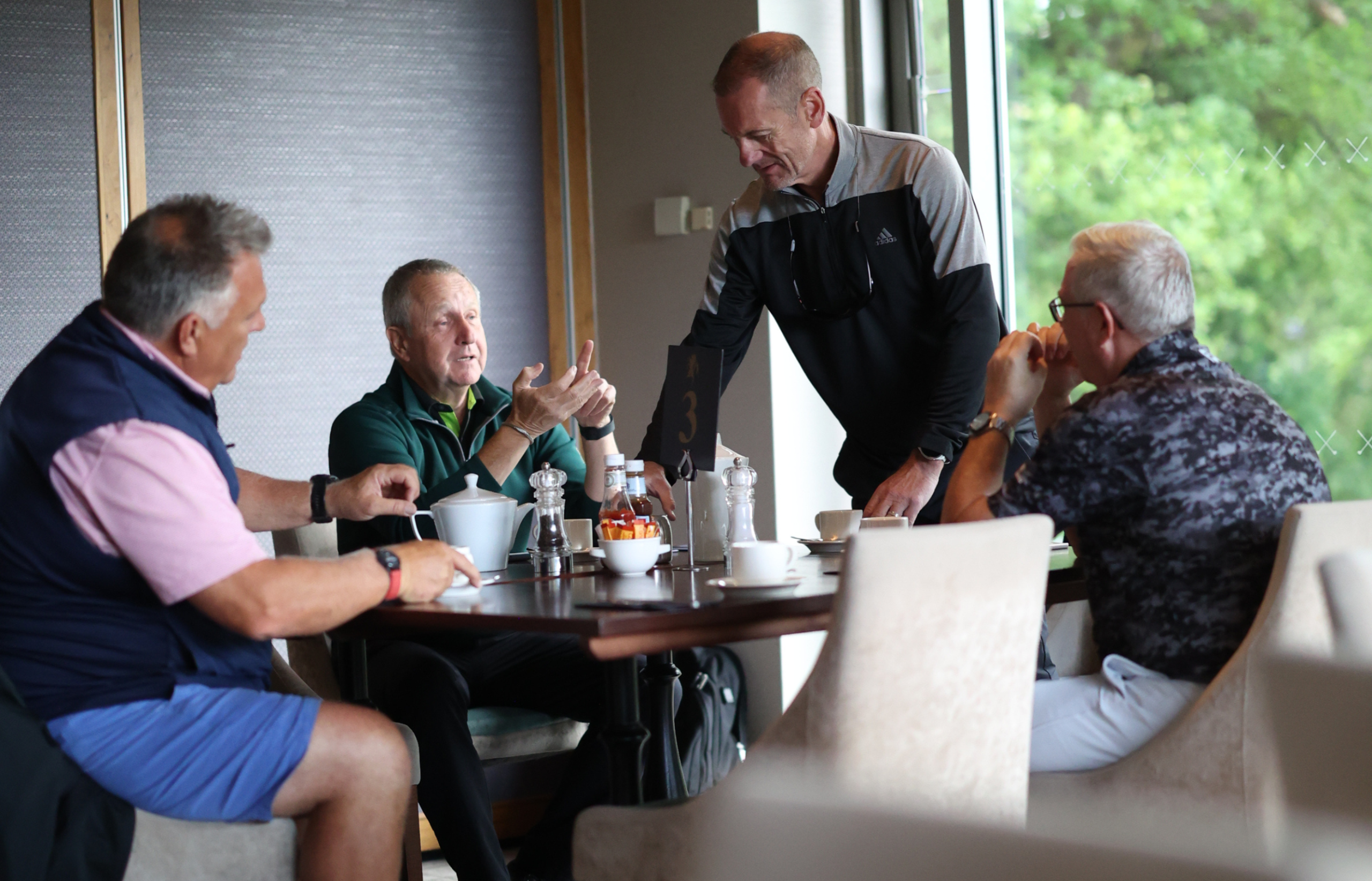pitch property members chatting around a table